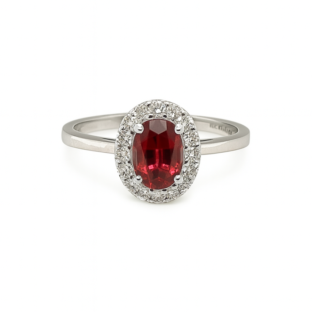 ring with a red gemstone and diamond accents on a white background