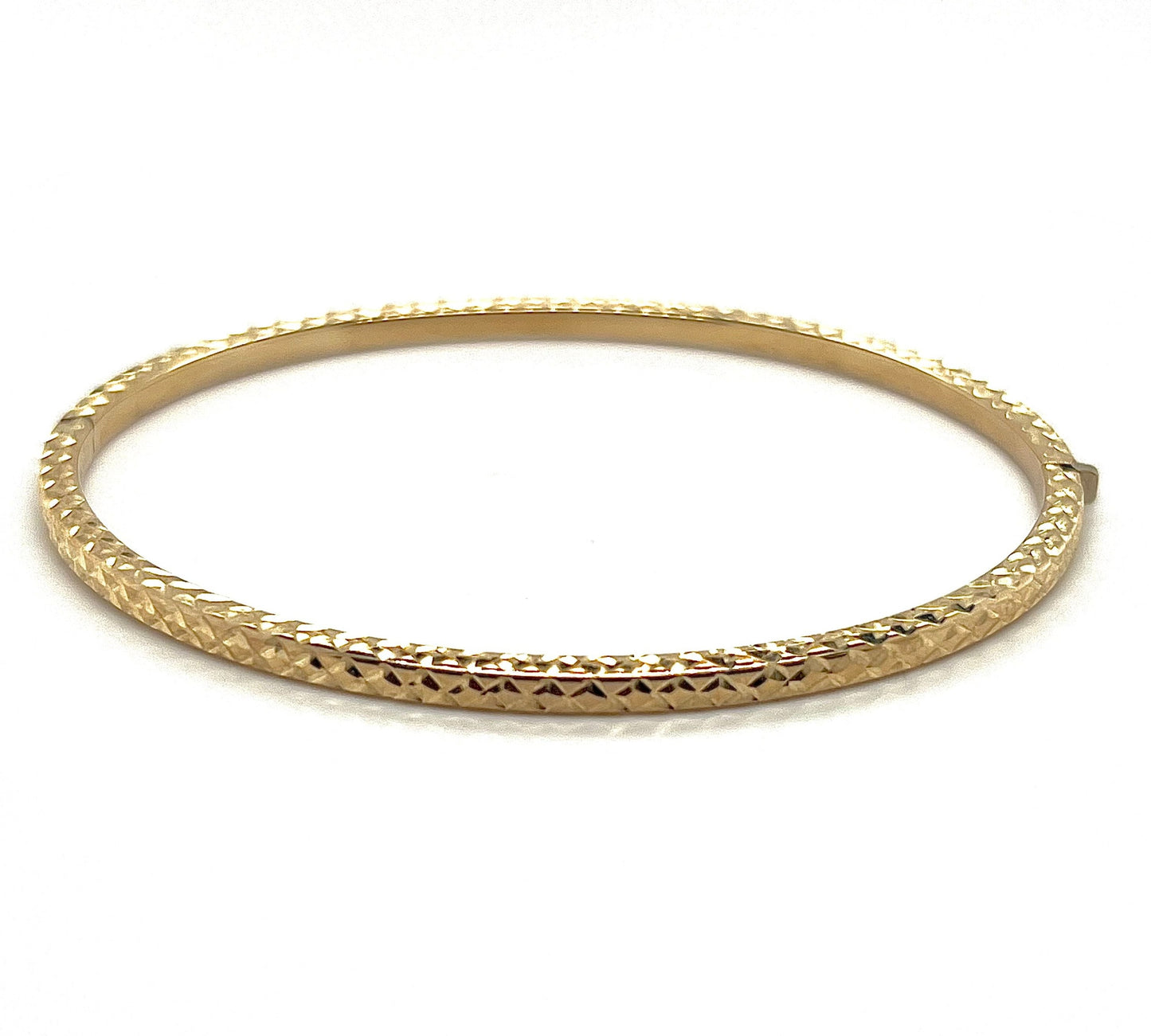 A 9k yellow gold patterned bangle with intricate detailing, displayed against a white background.