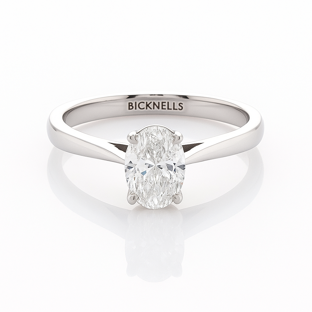 A Platinum 0.90ct Oval Cut Engagement Ring with a D/VS2 color and clarity certified by GIA, featuring a clear, well-cut oval diamond in a classic six-prong setting.