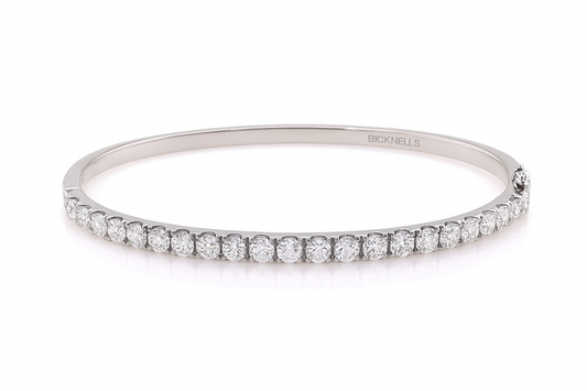 18k White gold bangle with diamonds on a white background