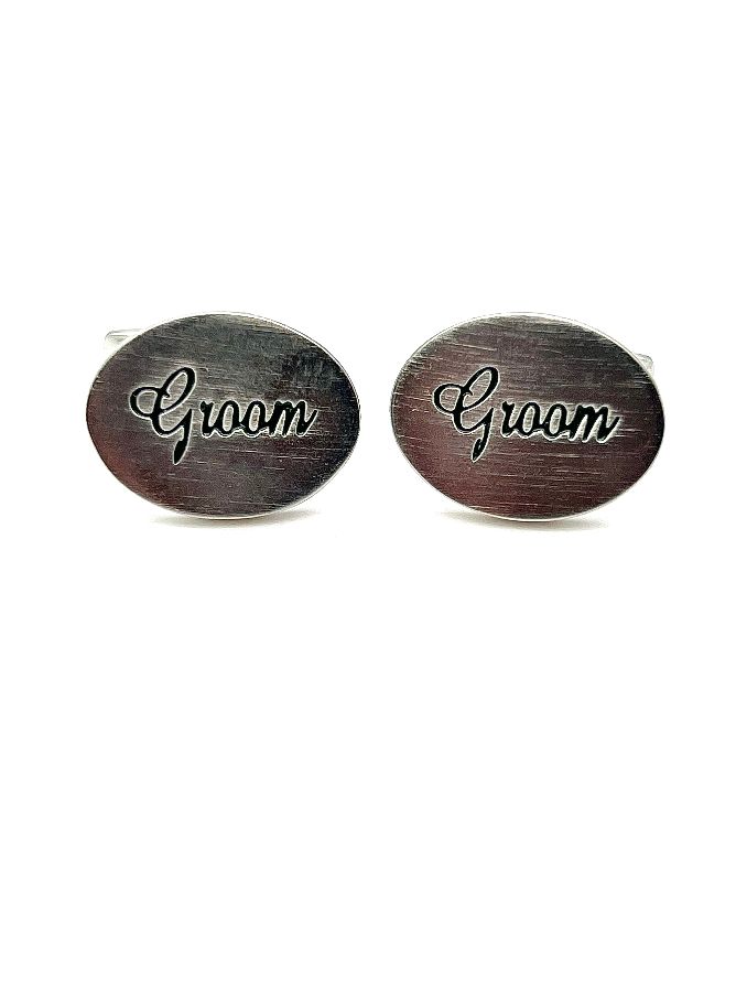 A pair of groom cufflinks with the word 'GROOM' engraved in a classic font.