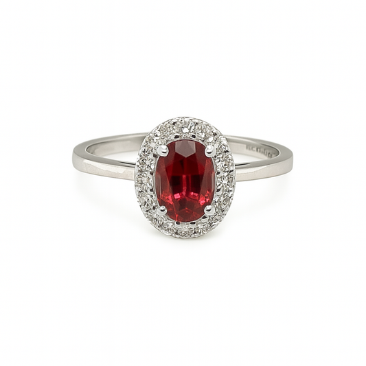  ring with a red gemstone and diamond accents on a white background