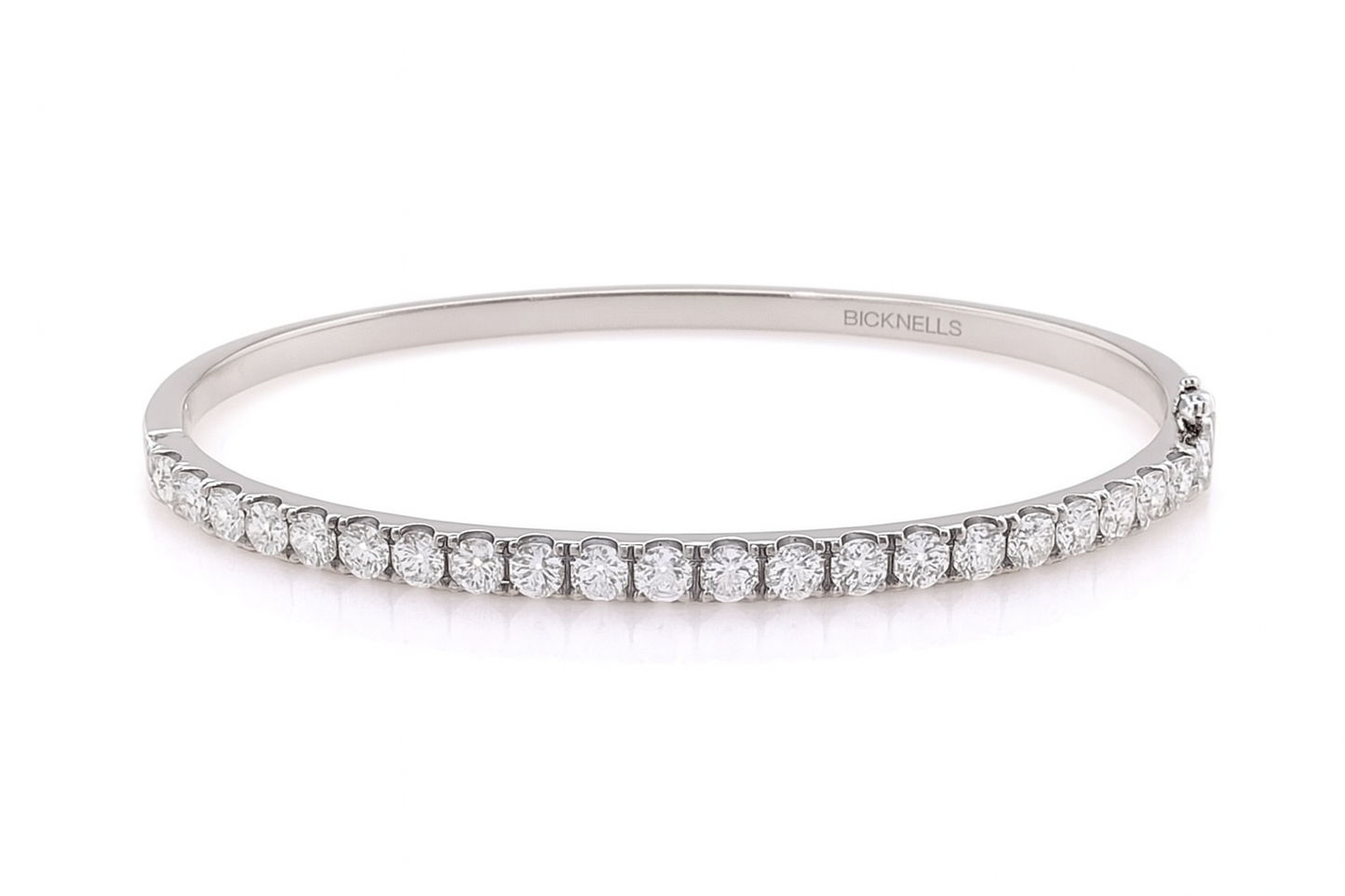 18k White gold bangle with diamonds on a white background