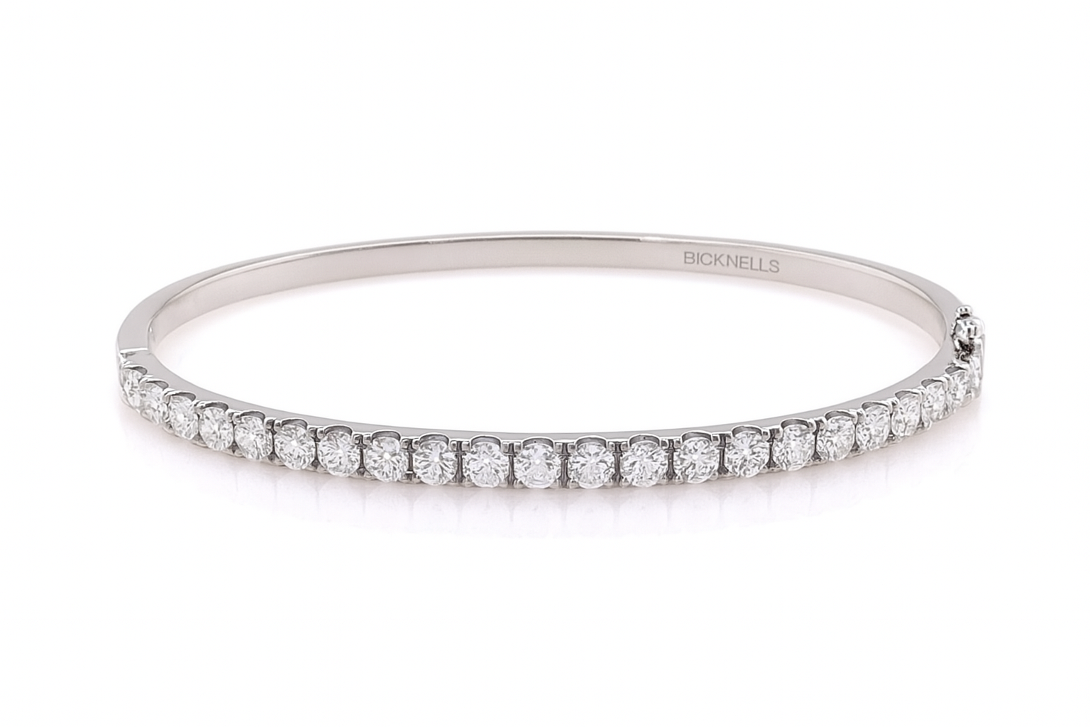 18k White gold bangle with diamonds on a white background
