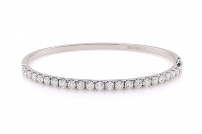 18k White gold bangle with diamonds on a white background